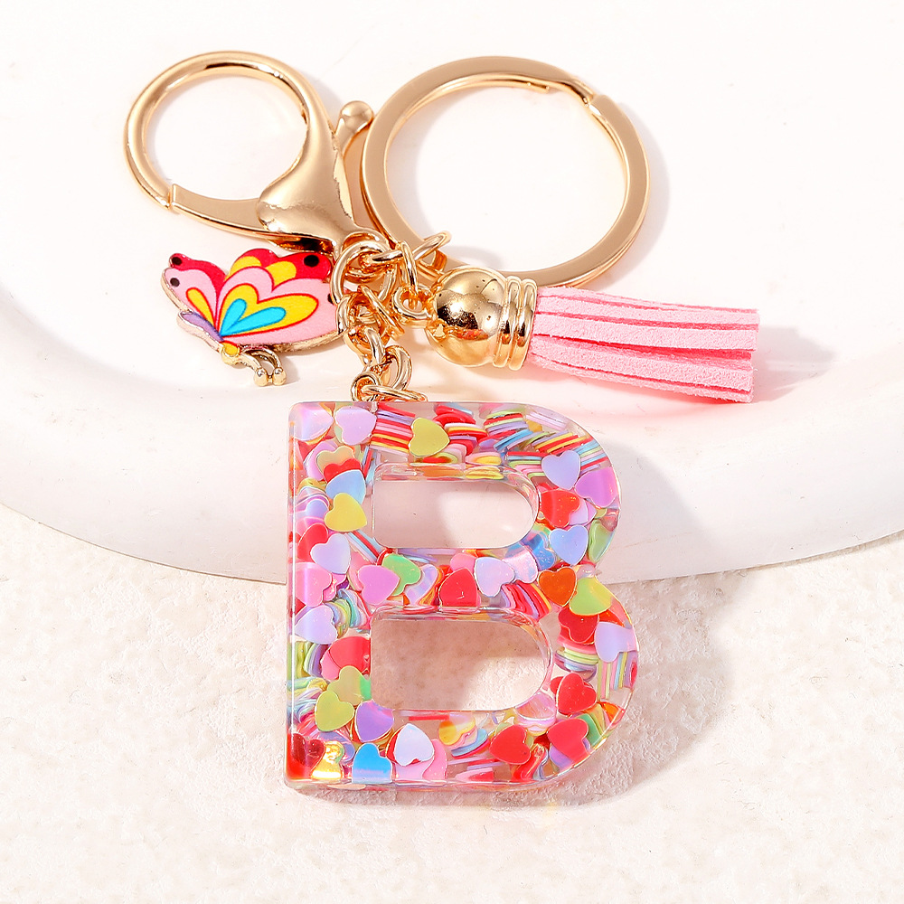 2024 puntos transfronterizos de resina de sequilla rosa 26 letras inglesas llavero colgante mariposa fringe accesorios