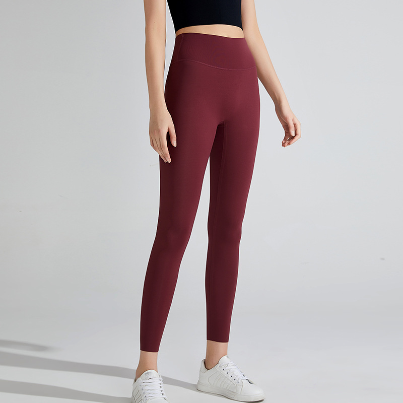 Nuevos pantalones de yoga desnudos transfronterizos Lycra de cintura alta de mujer pantalones de fitness de levantamiento de cadera deportes al aire libre ropa de yoga ajustada de secado rápido