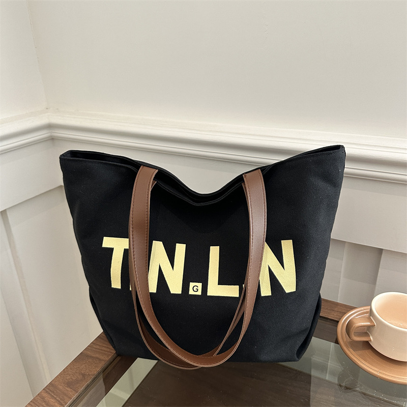 Bolsa de lona de nicho relajada bolsa de hombro para mujeres de gran capacidad 2025 primavera estudiante viaje bolsa de mano