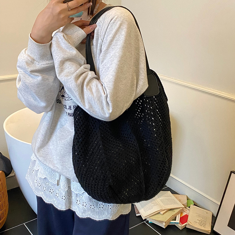 Bolso Tote de gran capacidad hueco tejido femenino 2025 nuevo bolso de playa de vacaciones junto al mar bolso tejido de paja de alta gama coreano