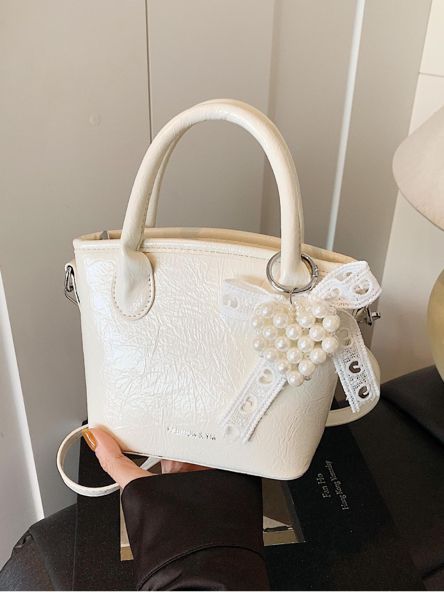 Bolso de cubo de mano súper caliente de comercio exterior 2025 nuevo bolso de hombro de tendencia salvaje de moda bolso de mensajero de nicho de alta gama de moda