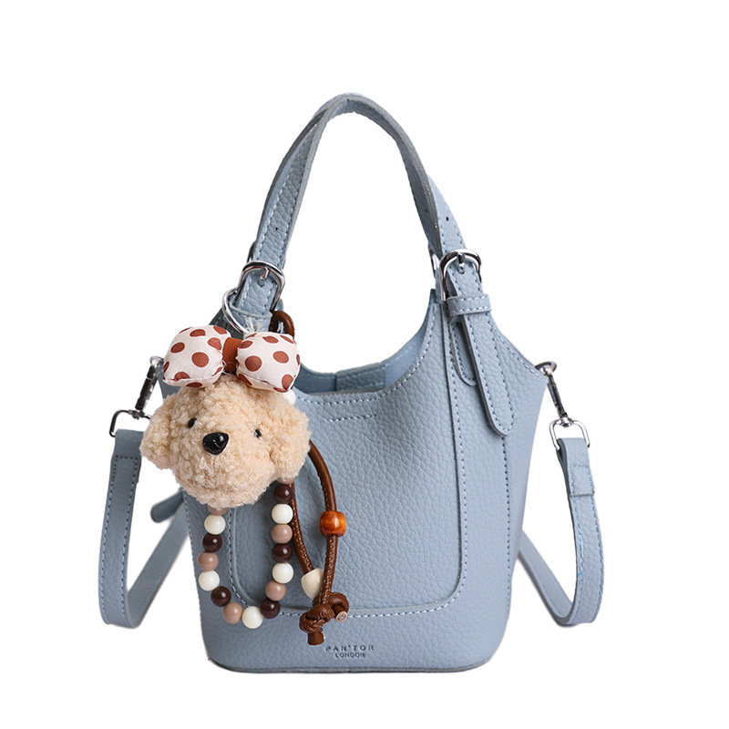 2026 nueva moda versátil cesta de verduras portátil bolso de cubo de agua de alta calidad litchi patrón ligero bolso de lujo bolso de mochila
