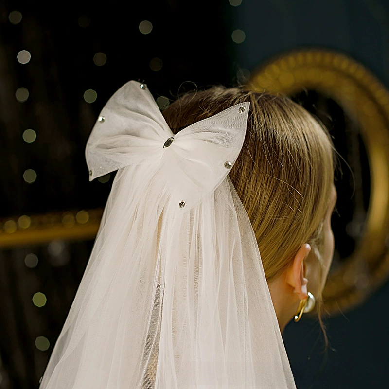 Cute short white bride's veil with bow
