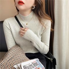 帆の泰のセーターのニットの女性の秋冬の半高襟の底のシャツの百合の洋風の長袖の中で身を修める上着の女性を掛けます。