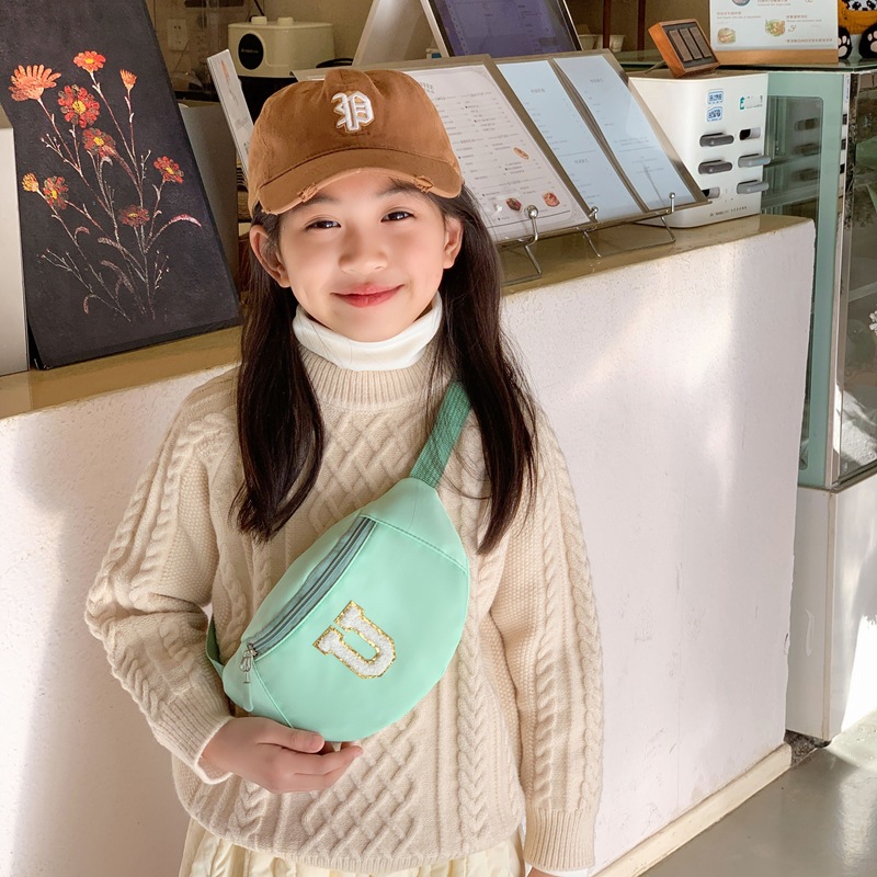 2026 nuevo comercio exterior bolso de cintura para niños letras de moda coreana bolso de pecho para niños y niñas simple bolso de bebé de color sólido