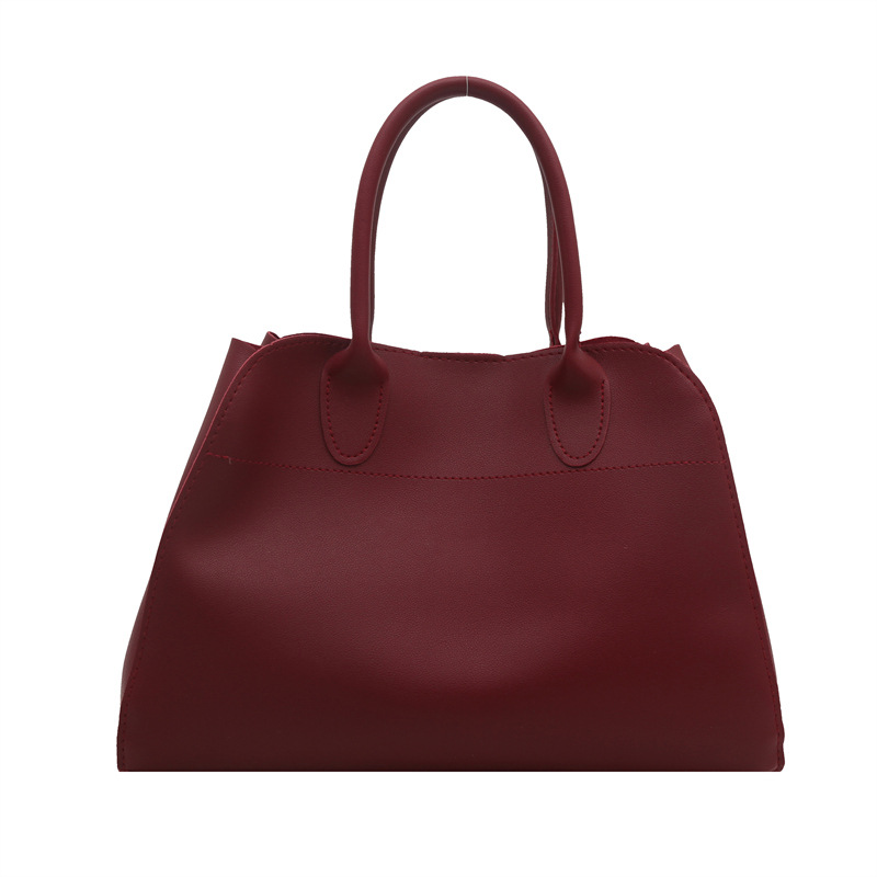 Europa y los Estados Unidos de moda retro sensación extranjera de gran capacidad bolso de cubo portátil de mujer 2025 primavera nueva moda simple bolso de tote