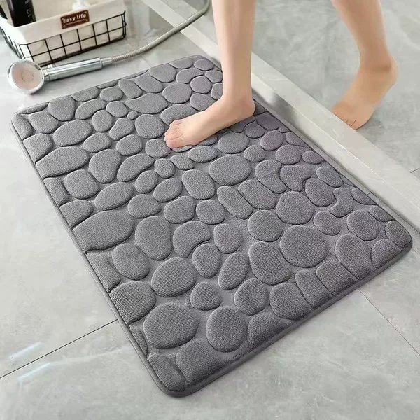 Embossed pebble-patterned coral fleece bath mat, absorbent and non-slip, suitable for bathroom and entryway, durable, easy to clean, and resistant to dirt