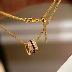 赤い本の爆発物がバラのネックレスを点滅させて、レトロな高級感があります。