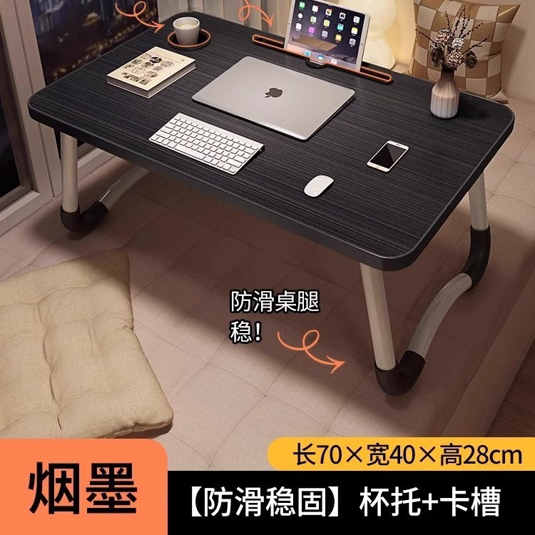 折り畳み可能なベッドの上の小さなテーブルは机のノートパソコンのテーブルを勉強します。|undefined