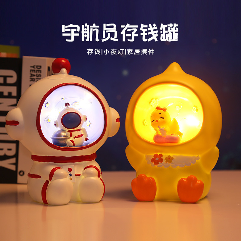 Astronaut ornaments creative children's piggy bank cartoon astronaut vinyl night light piggy bank wholesale gifts