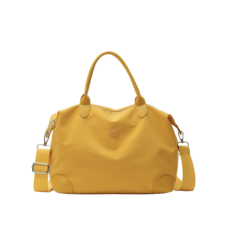 Nueva bolsa coreana para niños, bolsa de viaje ligera de gran capacidad, bolsa de mano casual simple de color sólido para niños y niñas