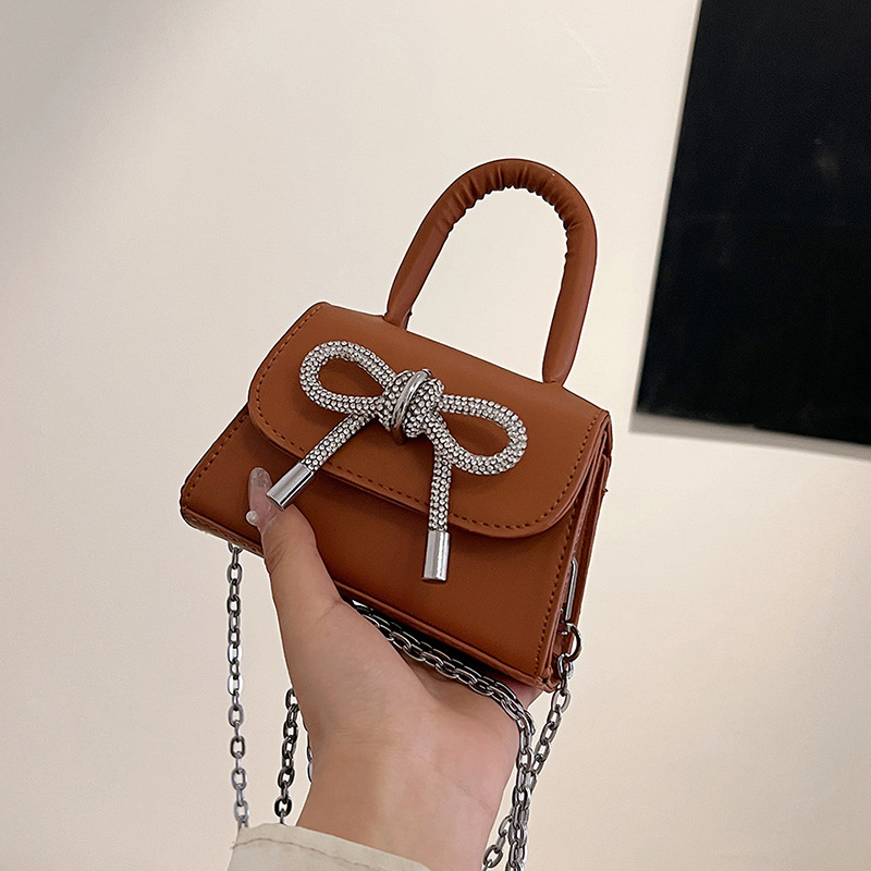 Moda al por mayor arco mini bolso mujer 2025 nuevo mochila bolso de hombro universal bolso de moda mujer