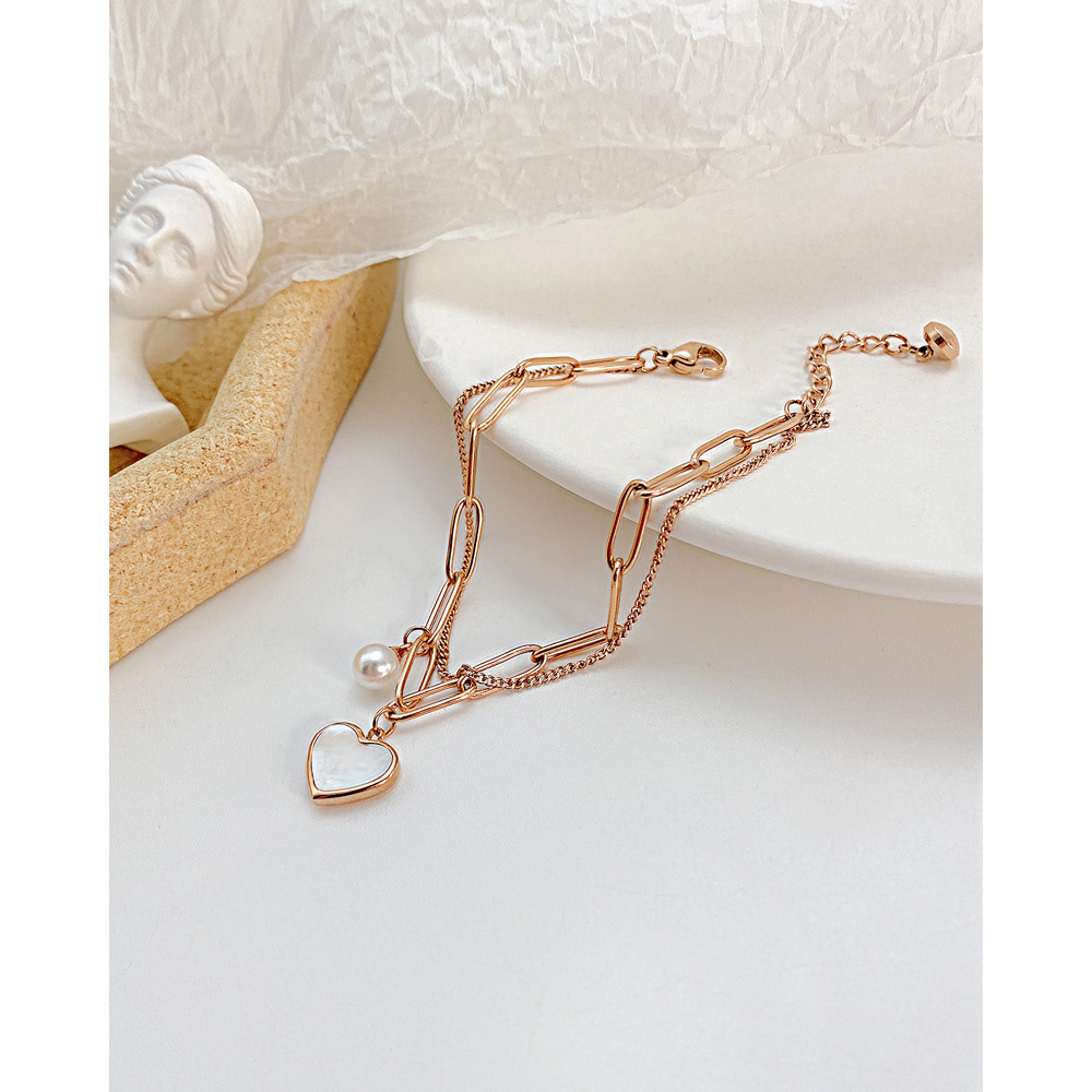 Nouveau design de niche tendance avec un tempérament double couche cool et unique, bracelet polyvalent en acier inoxydable avec perles en forme de cœur de pêche._voghion.com