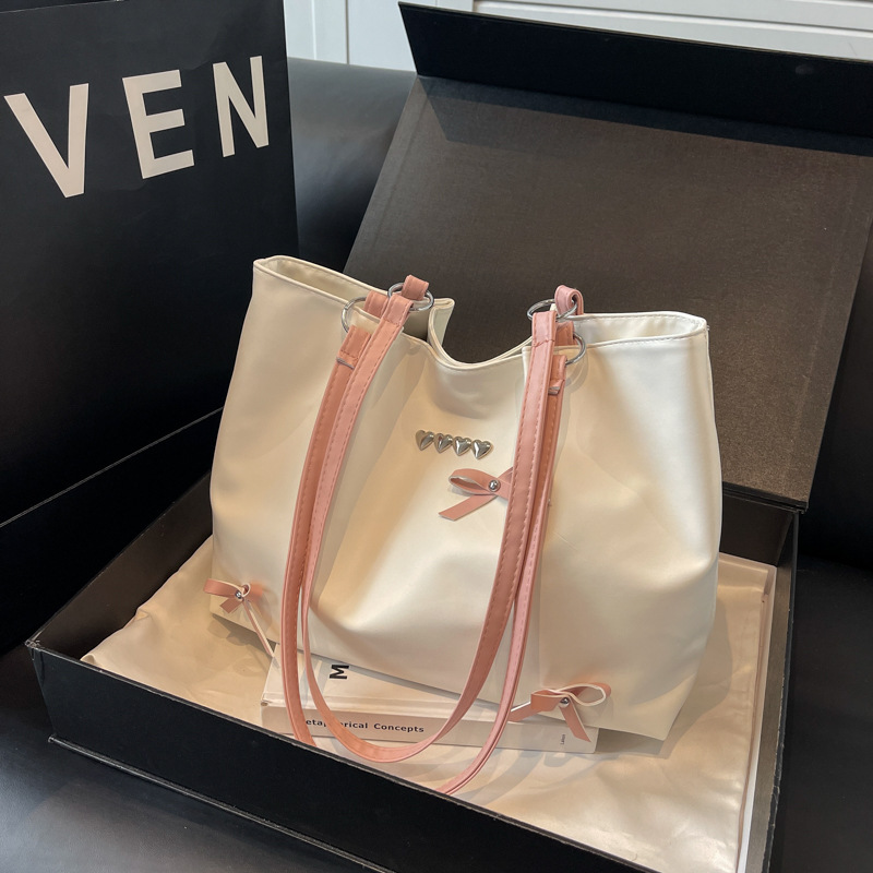 Este año popular bolso de viaje de moda coreana, bolso de hombro de estilo de ballet de mujer, textura alta, arco, bolso de mano.