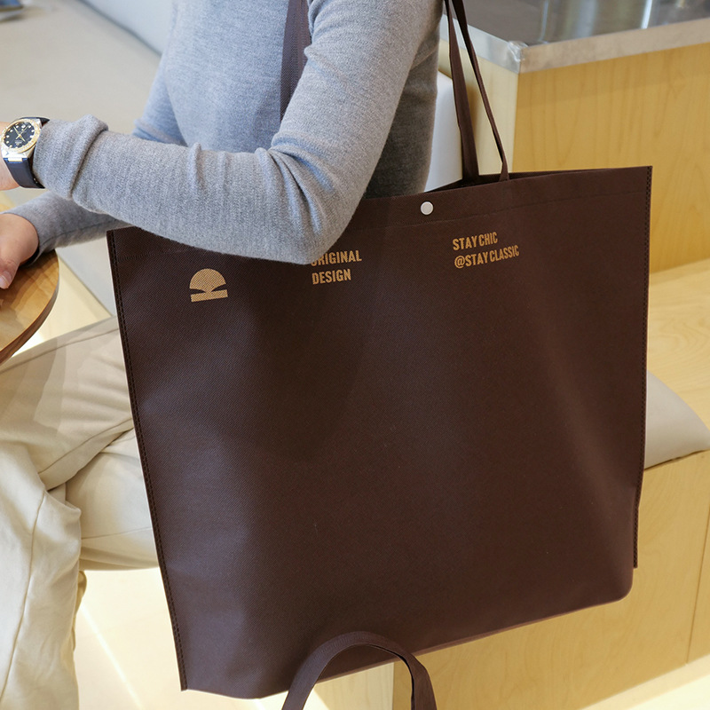 Bolso de mano no tejido de gran capacidad personalizado LOGO engrosado ropa de mujer protección ambiental bolsa de publicidad bolsa de compras de la tienda de ropa