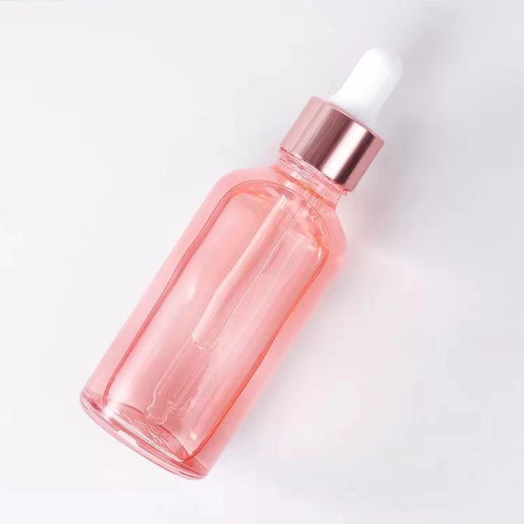 Venta al por mayor 10ml melocotón transparente vidrio Rosa botella de aceite esencial 20ml cosmética sub-botella Rosa anillo de oro botella de vidrio