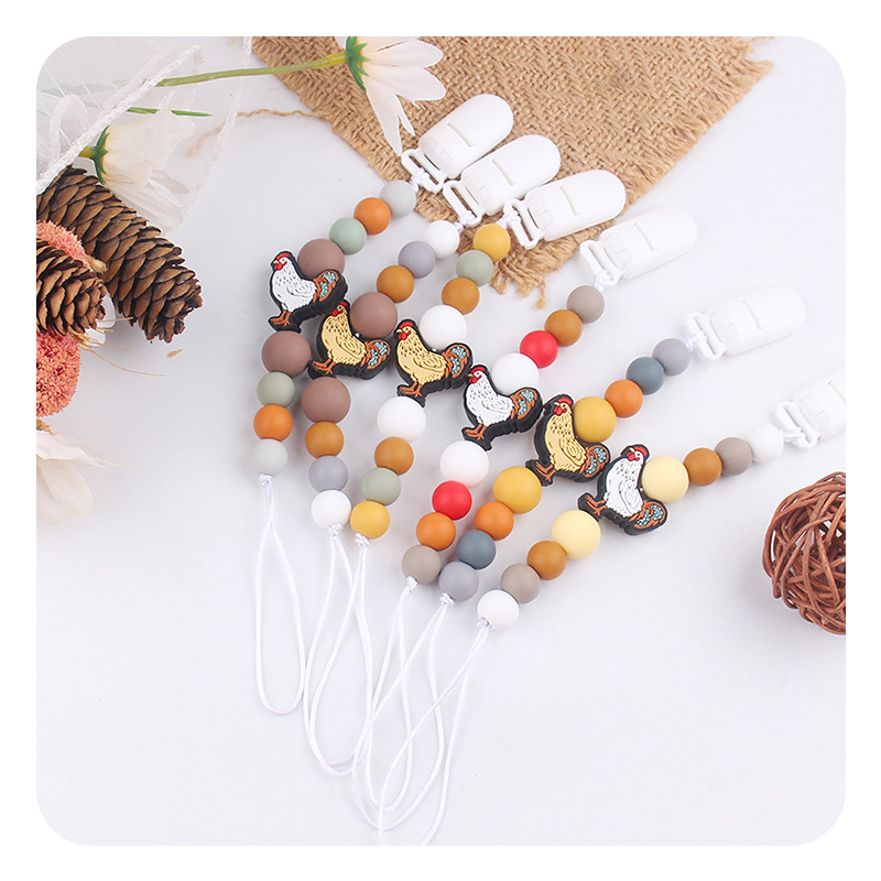 Nuevos bebés y niños series de dibujos animados gallo calmar la cadena de tetas bebés de silicona perlas de goma de dientes de mordida de dientes de mordida de dientes anti-caída cadena