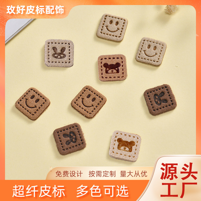 Factory wholesale microfiber embossed smiley face rabbit pattern leather label clothing shoes bag decorative leather brand trademark box label