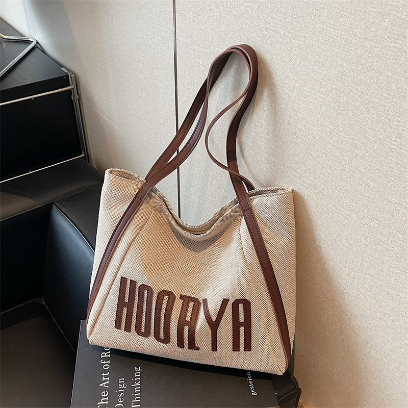 Bolsa de lona de gran capacidad para viajes 2025 nueva bolsa de mujer bolsa de hombro casual estilo exterior versátil bolso universitario