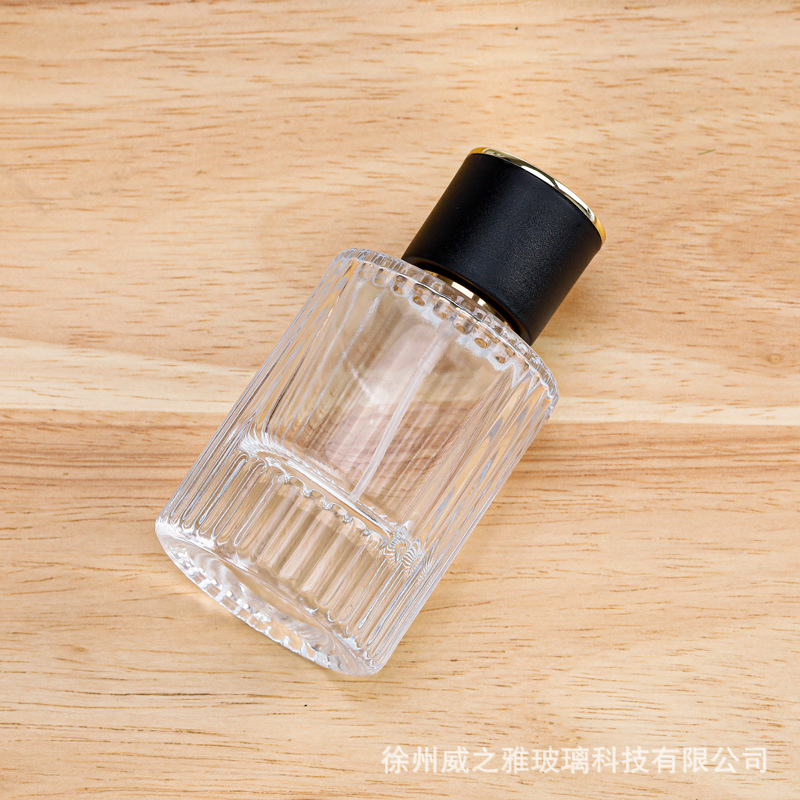 Venta al por mayor 30ml botella de dispensación de perfume cilíndrico 50ml botella de dispensación de loción de rayas verticales botella de rociador de presión botella de perfume