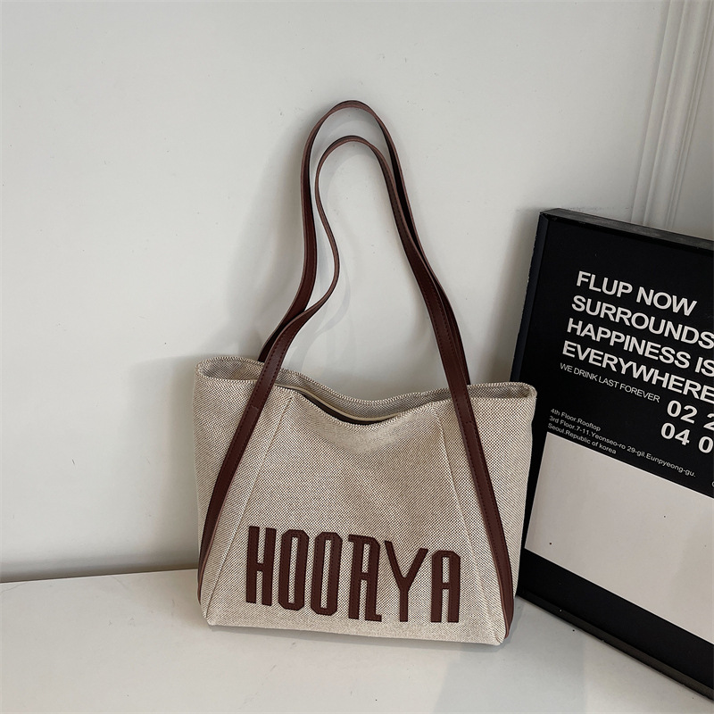 Bolsa de lona de gran capacidad para viajes 2025 nueva bolsa de mujer bolsa de hombro casual estilo exterior versátil bolso universitario