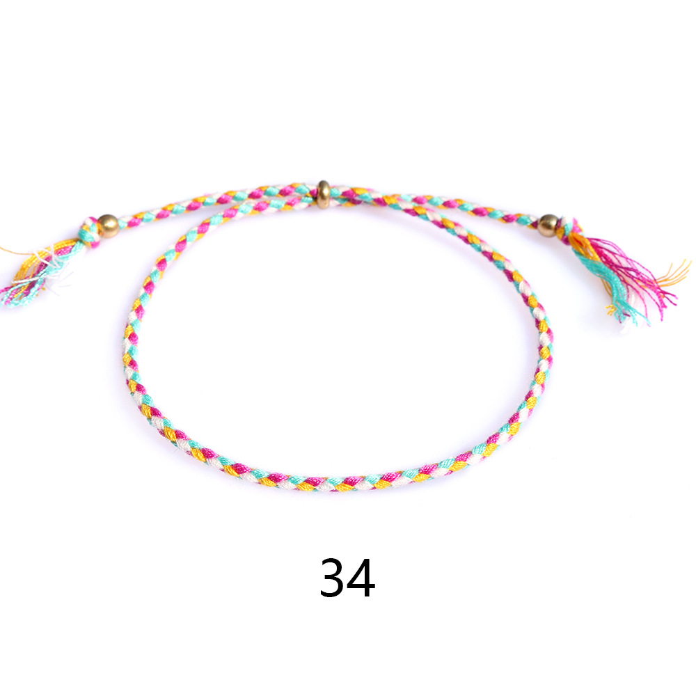 Amazon popular colorido cuerda de algodón amistad pulsera perlas de cobre borla pulsera tejida a mano ajustable hombres y mujeres pulsera