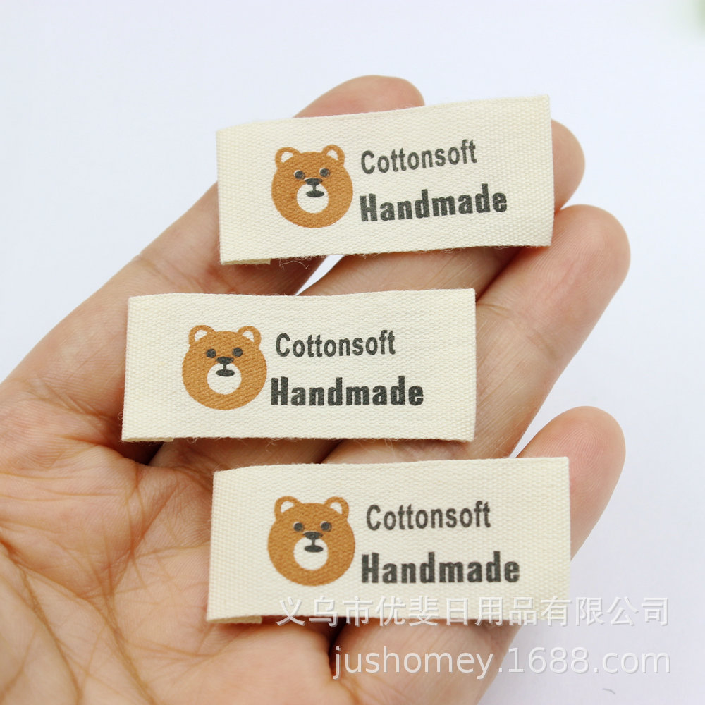 米色印字棉布标 双色熊头Handmade动物婴童鞋帽发饰布标diy配件