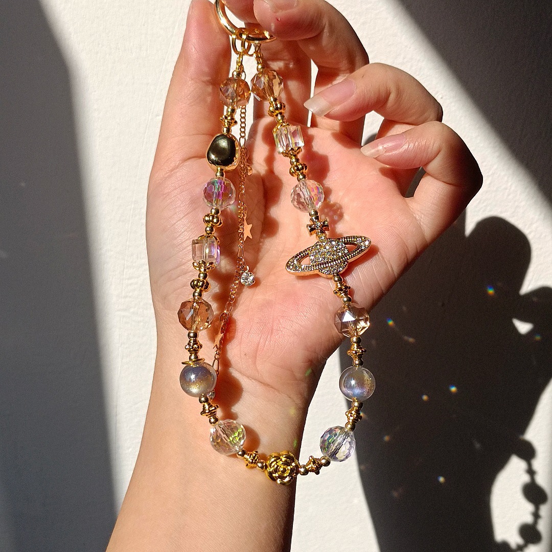 Cadenas de alta sensación de cuentas de cristal de Saturno parpadeante nuevo estilo chino bolso de cámara colgante corta cuerda de caso de teléfono móvil