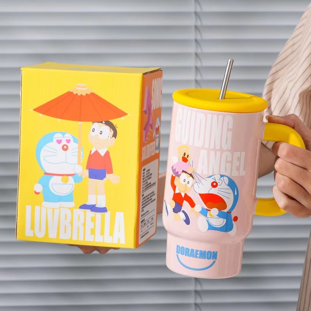Nuevos productos creativos Dingdong gato taza de cerámica con cubierta taza de agua de paja taza de café Doraemon taza de oficina de alto valor
