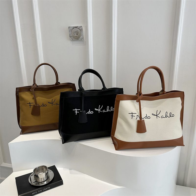 Casual retro alta sensación de bolsas portátiles de gran capacidad para mujeres 2025 nueva moda de color de viaje bolsas de mano