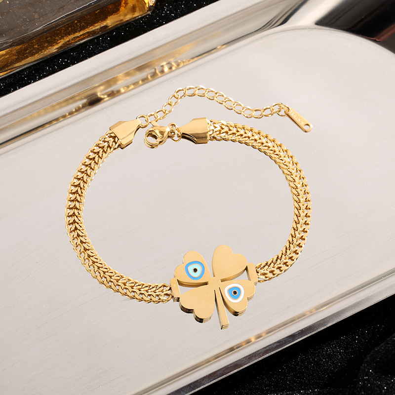 Amazon venta al por mayor transfronteriza Europa y América de moda ojos azules cuatro hojas colgante pulseras de acero joyas al por mayor