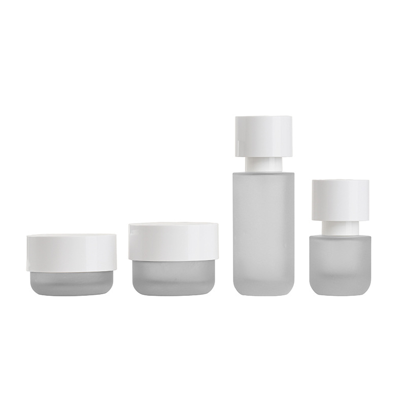 Botella de traje de vidrio cosmético de nuevo producto 30 ml / 100 ml botella de presión de emulsión exfoliante 30 - 50g material de embalaje de botella de crema