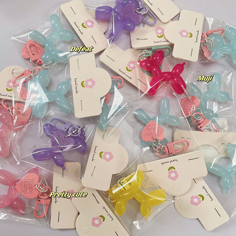 Pequeño Libro Rojo mismo lindo jalea globo láser perro llavero colgante colorido cachorro de dibujos animados teléfono llavero