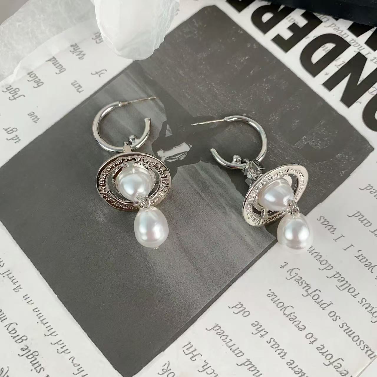 Classic three dimensional earrings drop-shaped from pearl with…