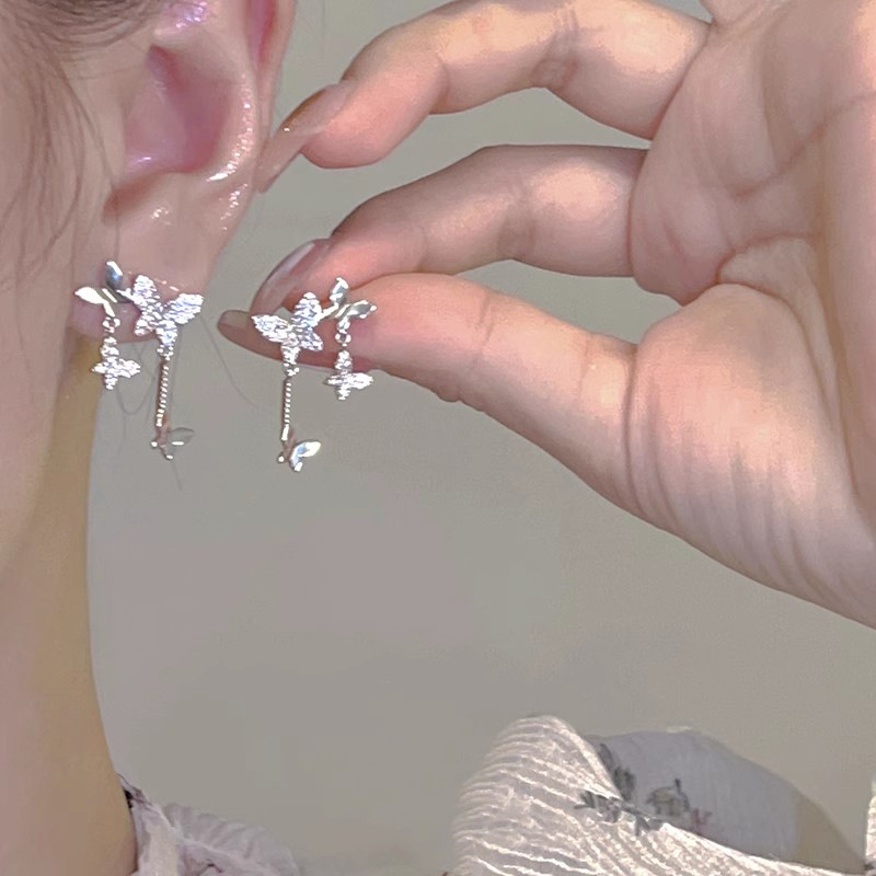 Diseño de nicho de alta gama borla larga sin orejas clip de oreja elegante estilo occidental de las mujeres cara-mirando pequeños nuevos pendientes de moda