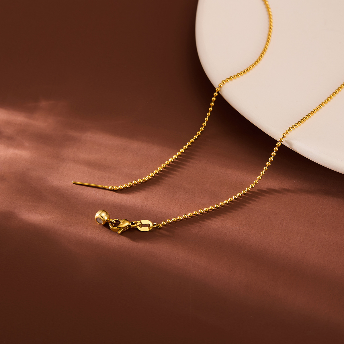 Cadena de esferas de aguja dorada (cada una envuelta por separado sin nudos)