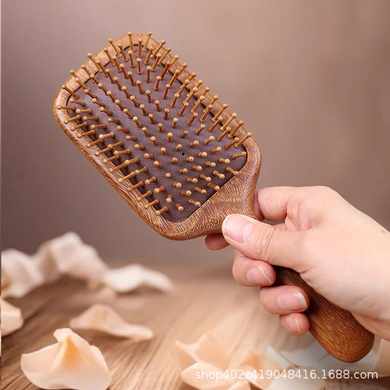 Golden Sandalwood Massage Comb 28 Teeth Round Scalp Meridian Brush Handheld in use