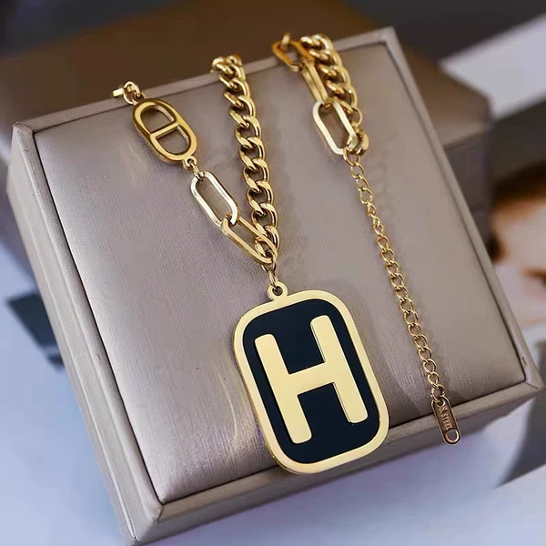 Golden necklace with letters, letter H