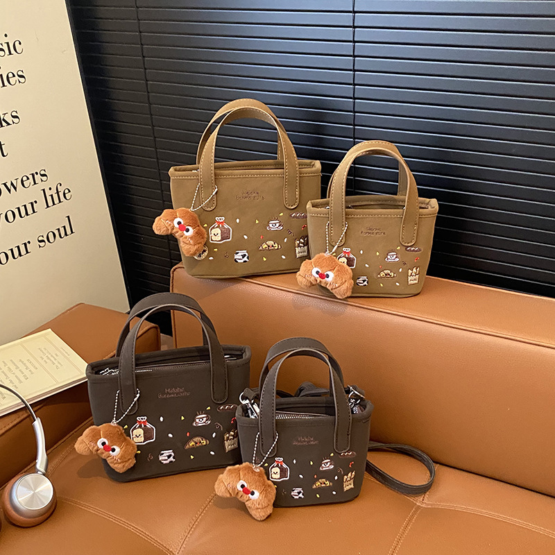 2026 nuevo comercio exterior bolsas de niños dibujos animados lindos colgantes de peluche bolsas de mano bordadas de moda bolsas de hombro para hombres y mujeres