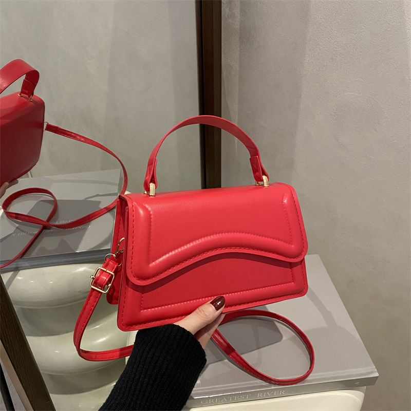 Texturas de moda en estilo de estilo de viaje ocio personalidad de primavera 2025 nuevo bolso de mano minimalista nicho bolso de mochila