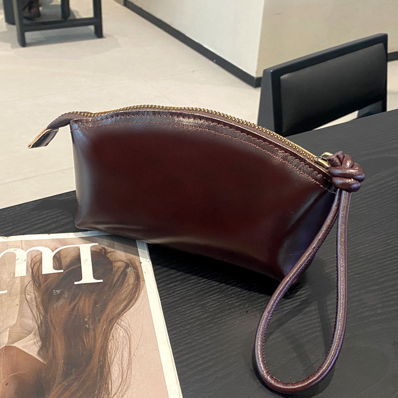 Viajes de moda primavera y verano nuevo nicho de diseño pu piel retrógrada elegante portátil bolso de bollo de gran capacidad transfronterizo para mujeres