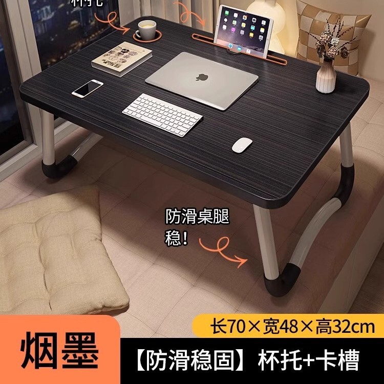 折り畳み可能なベッドの上の小さなテーブルは机のノートパソコンのテーブルを勉強します。|undefined