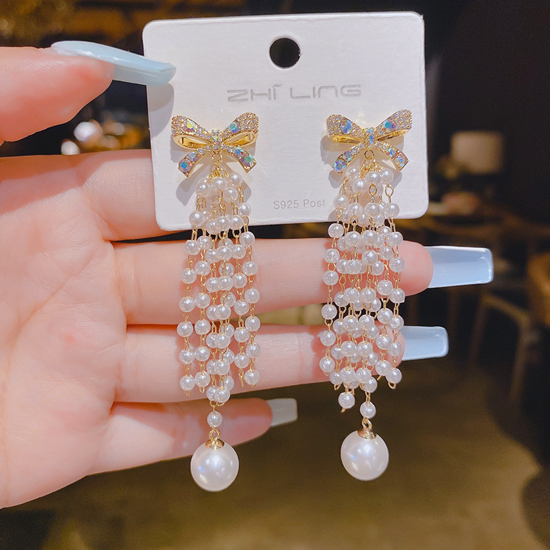 Fashionable earrings with zircon with bow pearl