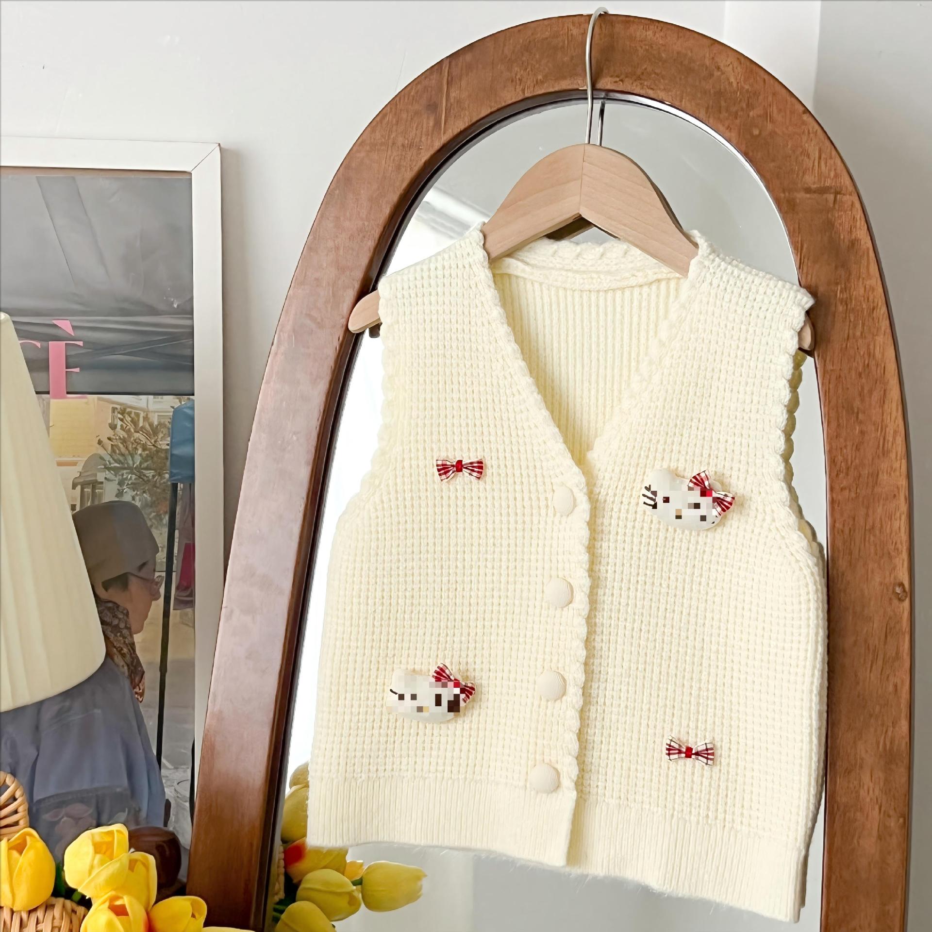 Retro color sólido V-collar chaleco cardigan bebé primavera y otoño nuevo estilo coreano de dibujos animados gatito arco chaleco de punto