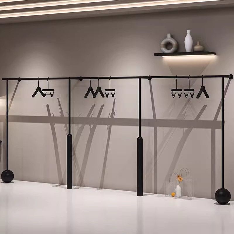 Tienda de ropa de hierro forjado estantes negros tiendas de ropa en línea especial percha de ropa de pared tienda de ropa de mujer estante de exhibición