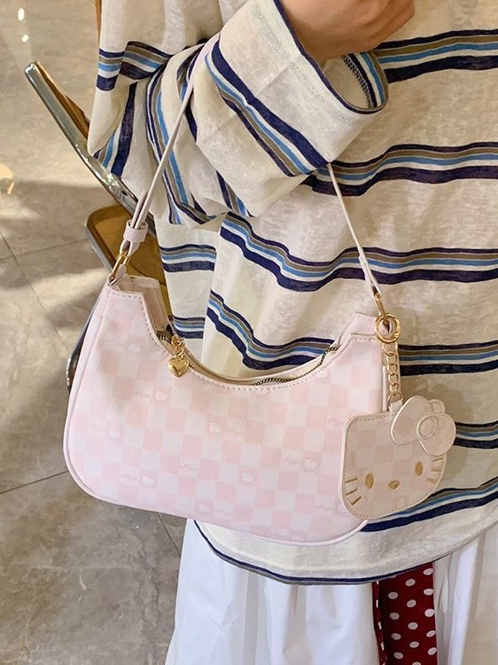 Moda de dibujos animados 2025 nuevo bolso de axilas de gato kt diseño de nicho coreano bolso de media luna de un solo hombro mochila de estudiante