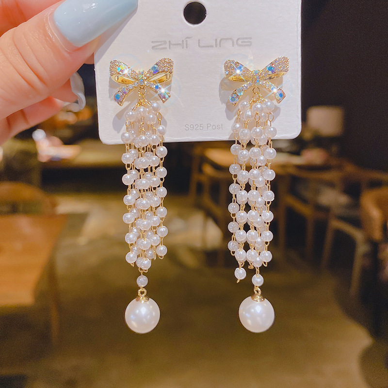 Fashionable earrings with zircon with bow pearl