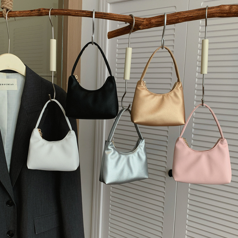 Nuevas bolsas de niños transfronterizas, bolsas de cambio de moda coreana de litchi para hombres y mujeres, bolsas de media luna de color sólido.