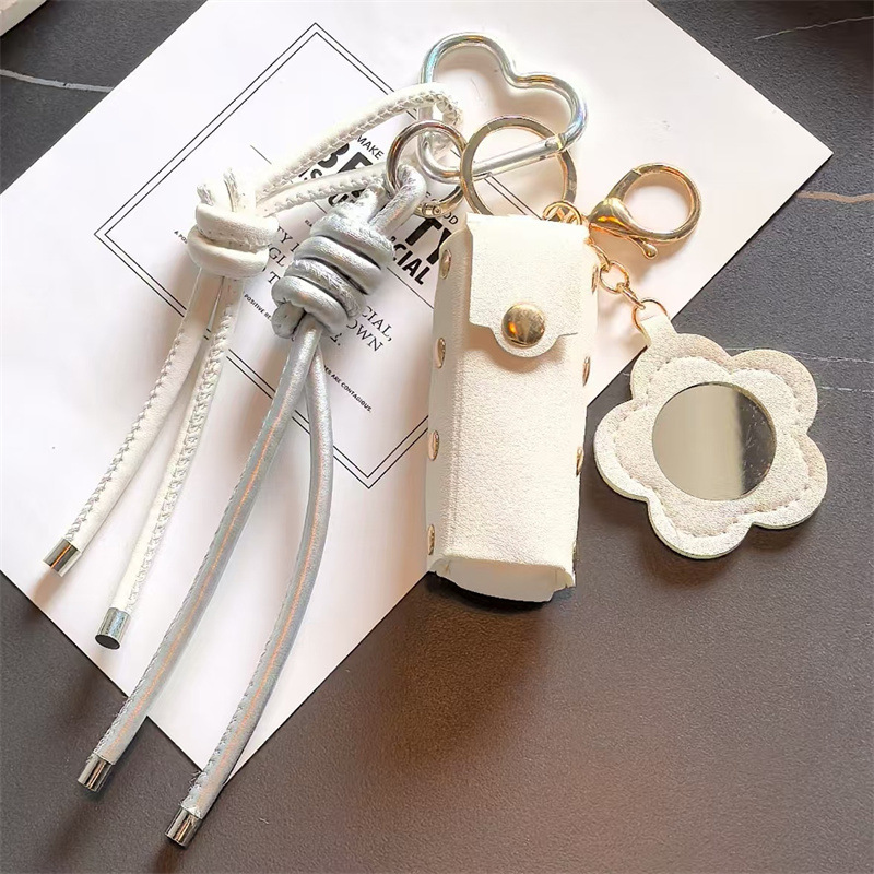 Espejo de cuero transfronterizo lápiz labial bolsas de llaves creativas flores portátiles maquillaje espejo bolsas colgantes accesorios de llaves PU