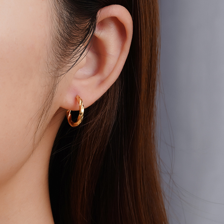 La tendencia de moda europea y americana torcida pendientes de acero inoxidable de mujer chapado en oro 18K redondo ligero lujoso sensación de alta calidad simple pendientes